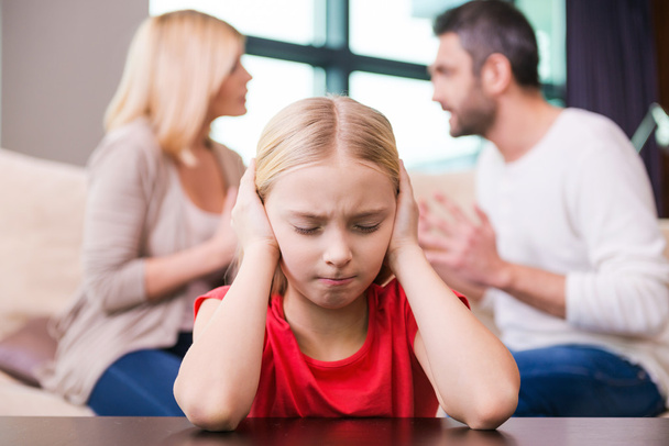 Depressed girl leaning and parents shouting at each other - Foto, imagen