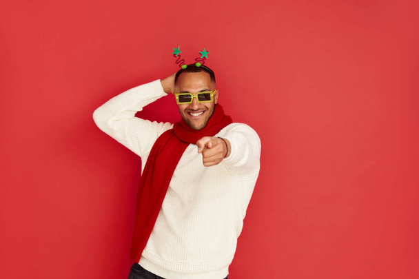 Multiracial Man Dancing Isolated. Portrait of Ecstatic Overjoyed Guy Dancing with Raised Arms, Smiling Excitedly, Celebrating Victory, Success. Indoor Studio Shot Isolated on Red Background  - Zdjęcie, obraz