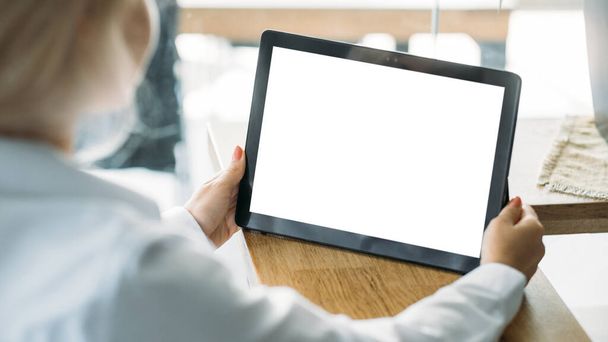 Office work. Digital mockup. Virtual technology. Unrecognizable woman working tablet computer with blank screen in light room interior. - Φωτογραφία, εικόνα