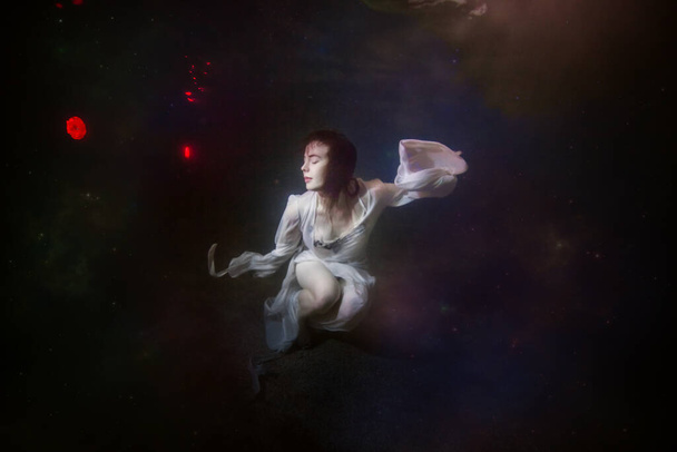 Abstract underwater painting of a girl dressed in a white dress underwater. - Photo, Image