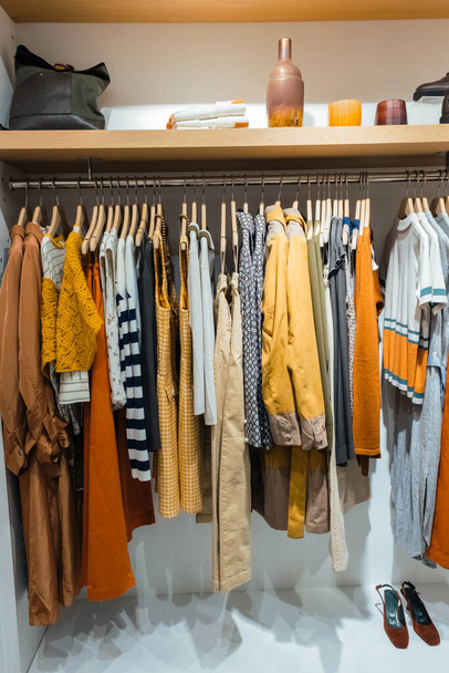 Collection of clothes in modern boutique. Clothes hanging on rack in fashion store - Photo, Image