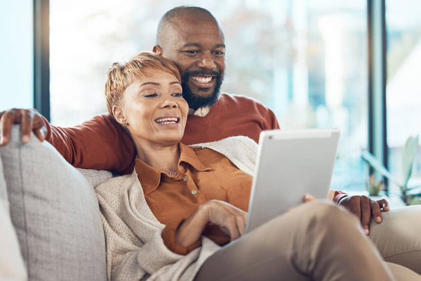 Senior black couple, tablet on sofa or reading social network, email or communication with smile. Mature black woman, happy black man on mobile technology and social media, relax on web app in home. - Foto, Imagem
