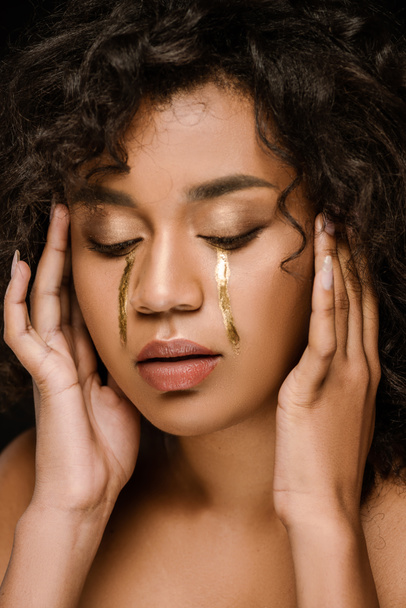 curly african american woman with golden tears on cheeks and closed eyes - Fotografie, Obrázek