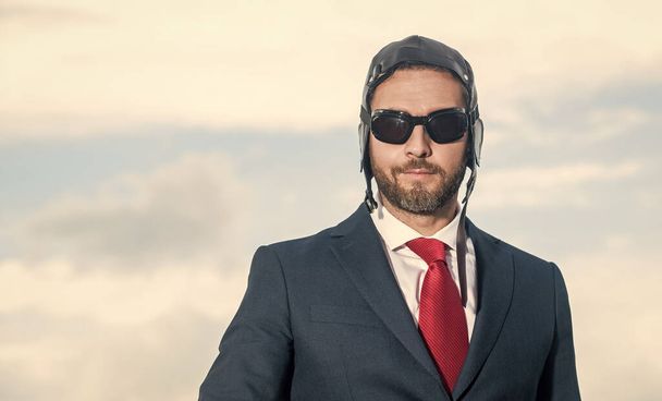 businessman in suit and pilot hat on sky background. - 写真・画像