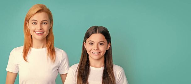 Mother and daughter child banner, copy space, isolated background. Happy woman mother and daughter child smile holding pot plants blue background, family - Foto, imagen