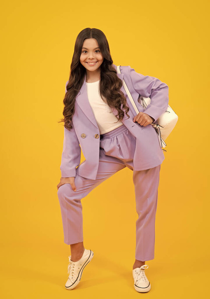School teen girl in with backpack. Teenager student on yellow isolated background. Learning, education and knowledge. Happy teenager, positive and smiling emotions of schoolgirl - Photo, image
