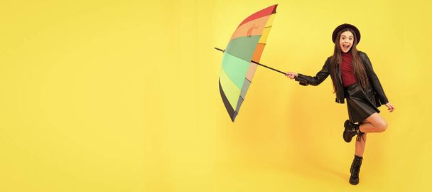back to school. fall fashion accessory. happy stylish girl in leather wear. Child with autumn umbrella, rainy weather, horizontal poster, banner with copy space - Fotografie, Obrázek