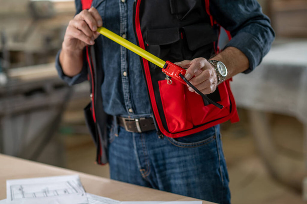 Carpenter. Close up picture of a man in a working vest - Foto, immagini