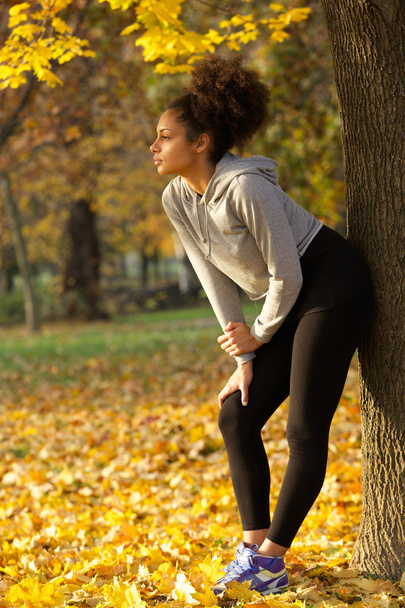 Beautiful young woman standing in park after work out - Photo, Image