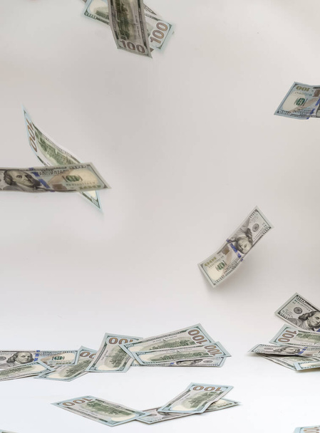 Falling paper money dollar bills on white background - Фото, изображение