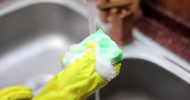 Hand squeezes washcloth with detergent. Closeup of washcloth with dishwashing foam - Footage, Video