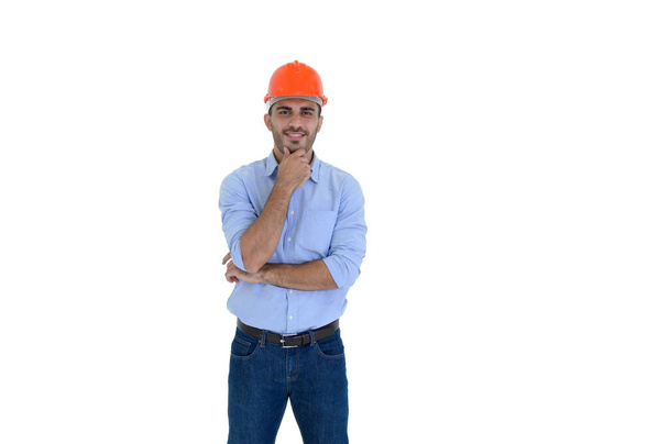 Portrait of young construction engineer wear orange hardhat, standing on white background with copy space - Foto, Imagem