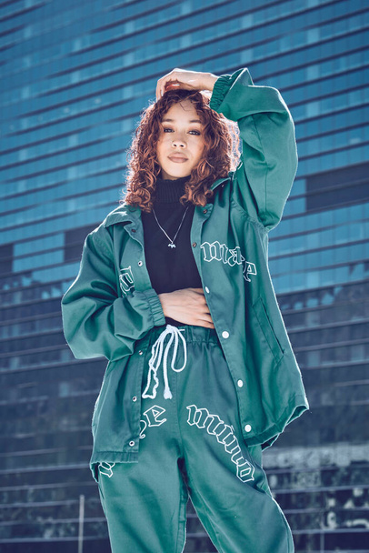 Fashion, portrait and woman with, stylish, urban and street designer clothes in the city of Tokyo. Creative, cool and young fashion model girl with style, trendy and edgy by buildings in town. - Foto, Imagen