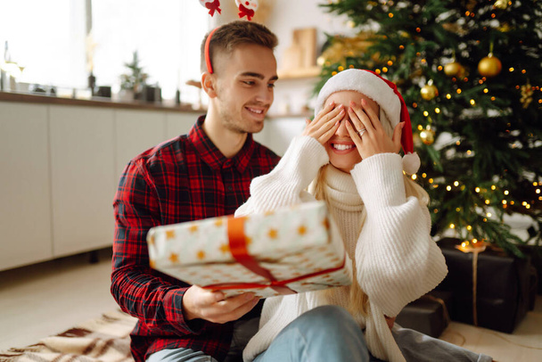 Young couple have Christmas surprise for holiday. Romantic day. Winter holidays. - Fotó, kép