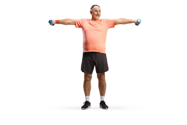 Full length portrait of a mature man exercising with small weights isolated on white background - Fotoğraf, Görsel