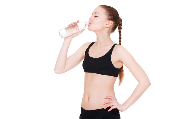 Sportswoman drinking water - Photo, Image