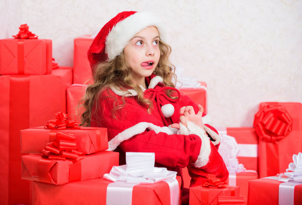 Explore christmas gifts. Unpacking christmas gift. Kid excited about opening christmas present. Girl celebrate christmas. Santa bring her gift. New year holiday tradition. Winter happiness concept. - Photo, Image