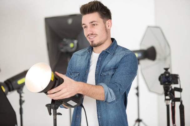 photographer preparing studio with spot lamps - Photo, Image