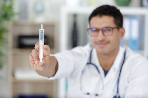 doctor in medical uniform with syringe - Фото, изображение