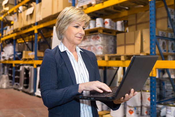 warehouse manager holding a laptop - Fotó, kép