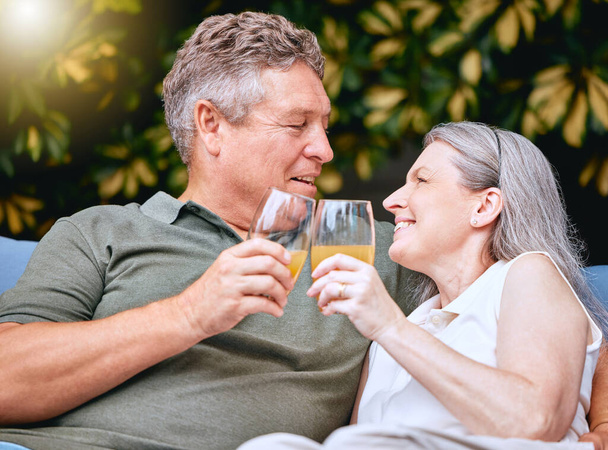Senior, couple and toast on vacation with drink, cocktail or juice to relax, romance or bonding in nature. Elderly man, woman and retirement with smile, happy and love with glass in garden together. - Foto, Imagem
