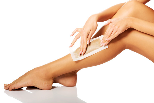Woman waxing her leg - Фото, изображение
