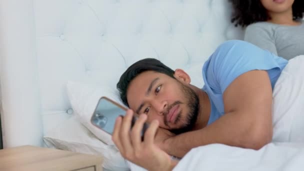 Couple, phone or cheating in house bedroom, home or hotel on social media, online dating app or sexting. Spying, curious woman or checking mobile technology on asian man affair or infidelity betrayal. - Footage, Video