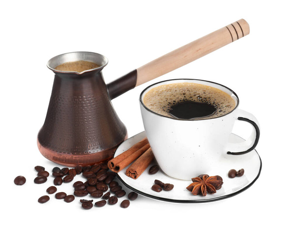 Metal turkish coffee pot with hot drink, beans and spices on white background - Foto, Imagem
