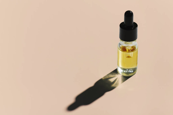 CBD oil in a clear, glass container with a dropper lid, isolated on a white background, to represent the legalized marijuana extracts concept. - Photo, Image
