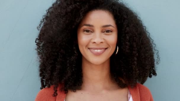Happy, smile and laugh with the face and head of an attractive black woman smiling on a gray background or wall. Closeup portrait of a carefree and beautiful female with a positive attitude and afro. - Footage, Video