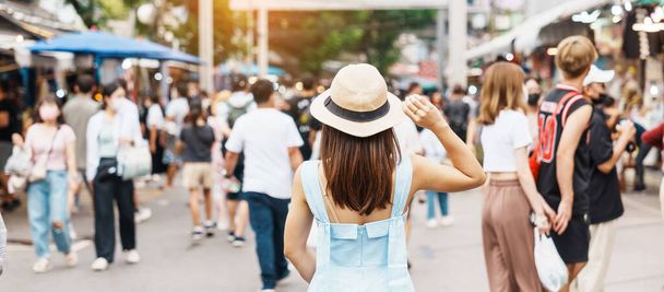 woman traveling with hat, Asian traveler standing at Chatuchak Weekend Market, landmark and popular for tourist attractions in Bangkok, Thailand. Travel in Southeast Asia concept - Valokuva, kuva