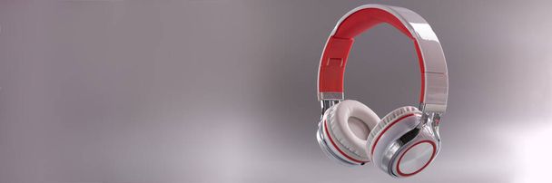 Close-up of modern headphones in red and white colour combination on grey background. Music, sound, technology and dj equipment concept - Foto, afbeelding