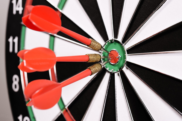 Three red darts in the target center - Foto, imagen