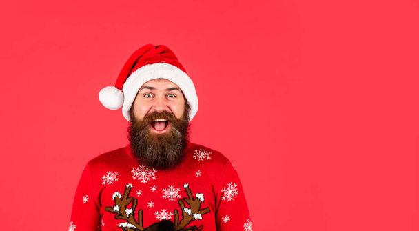 Brutal hipster favorite winter sweater red background. Santa man. Choose your winter. Bearded man santa hat. Winter holiday fun. New year party. Christmas time. Be prepared this festive season. - Foto, Imagen