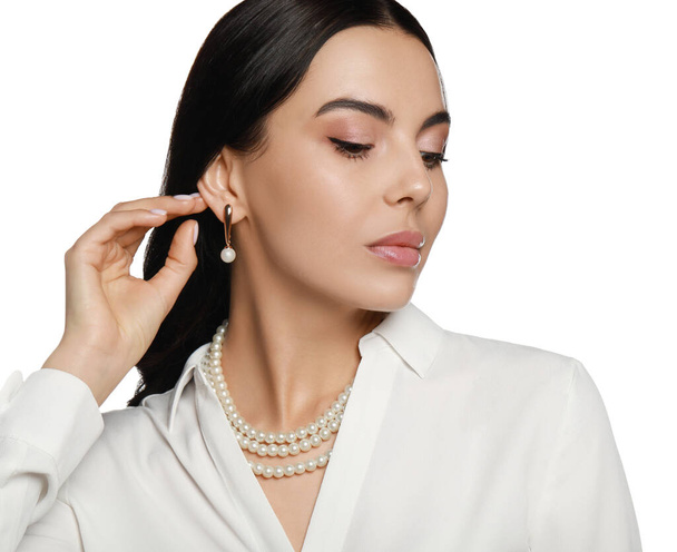 Young woman wearing elegant pearl jewelry on white background - Фото, зображення