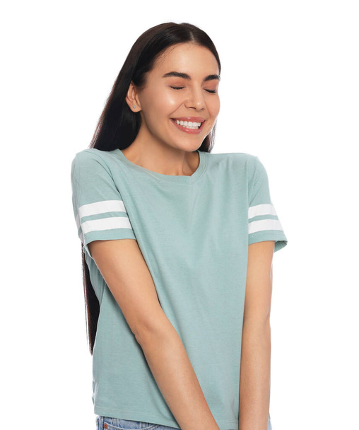 Embarrassed young woman in shirt on white background - Fotoğraf, Görsel