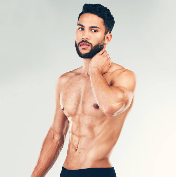 Bodybuilder, strong and topless man showing his abs and fit body on a stufio background. Fitness, shirtless handsome young man and posing for strength, muscle and bodybuilding or weightlifting. - Foto, imagen