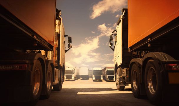 Semi TrailerTrucks on Parking with The Sky. Shipping Container Diesel Trucks. Trucking. Truck Wheels Tire. Delivery Transit. Lorry Tractor. Industry Freight Trucks Logistics Cargo Transport. - Photo, Image
