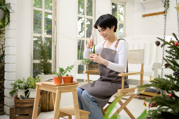 A young Asian woman enjoys gardening at home, Health care and wellbeing concept  - Valokuva, kuva
