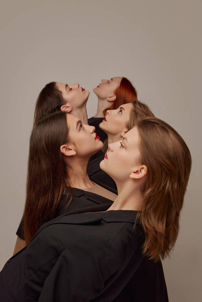 Young beautiful women in black jackets and red lipstick makeup posing over grey background. Diversity of beauty. Concept of beauty, freedom, emotions, extraordinary fashion, modern style, youth - Zdjęcie, obraz