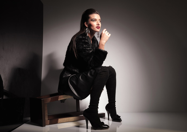  young casual woman sitting on a stool - Valokuva, kuva