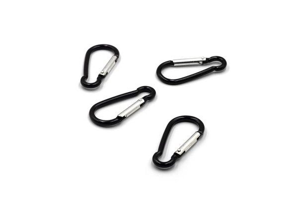 Black aluminium alloy carabiner for camping and outdoor activities. Use it to clip objects together. Isolated on white background. - Foto, Bild