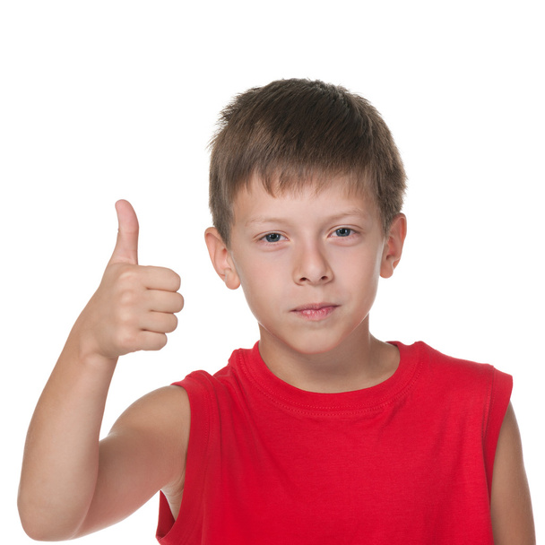 Smiling boy holds his thumb up - Photo, Image