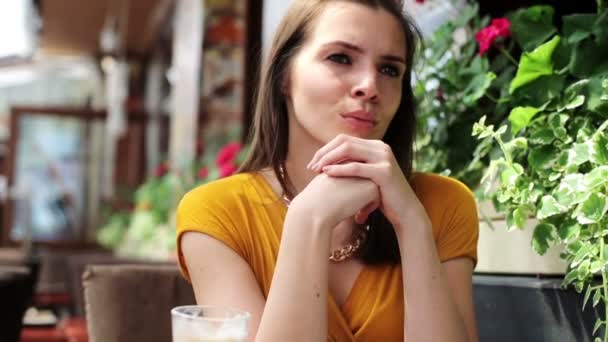 Portrait of beautiful sad, serious woman in restaurant - Filmmaterial, Video