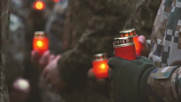 Remembrance day lest we forget. Memorial Day with candles. Commemorative candles are lit. Ukrainian Soldiers in military uniform holding red candles. Servicemen at military parade - Footage, Video