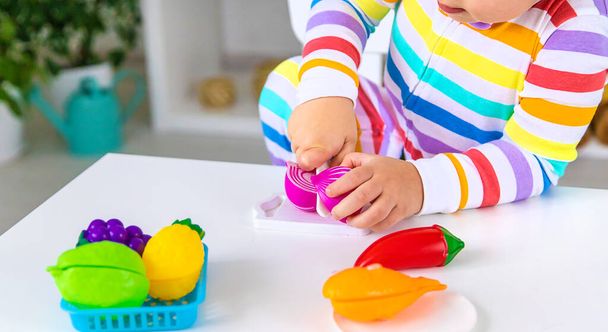 Child plays kitchen and food toys. Selective focus. Kid. - Fotó, kép