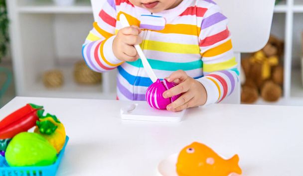 Child plays kitchen and food toys. Selective focus. Kid. - Foto, imagen