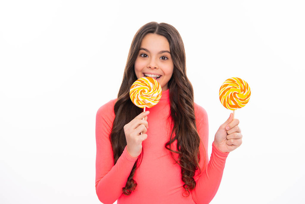 Teenage girl with candy lollipop, happy child 12, 13, 14 years old eating big sugar lollipop, sweets candy. Happy girl face, positive and smiling emotions. - Foto, Bild