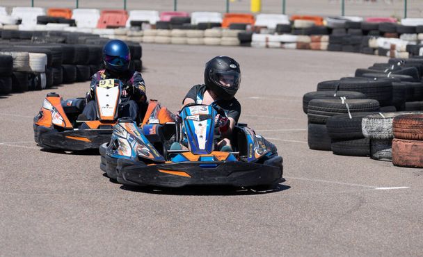 ODESSA, UKRAINE - August 7,2022: Extreme car racing. Healthy lifestyle. Tense moments of race. People are into motorsports. Karting. Hobbies, sport, recreation, lifestyle. Risk and excitement on court - Foto, immagini