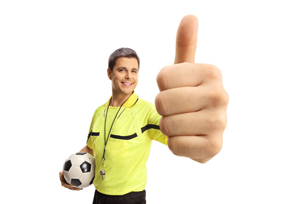 Football referee holding a ball and a gesturing thumb up sign isolated on white background - Φωτογραφία, εικόνα